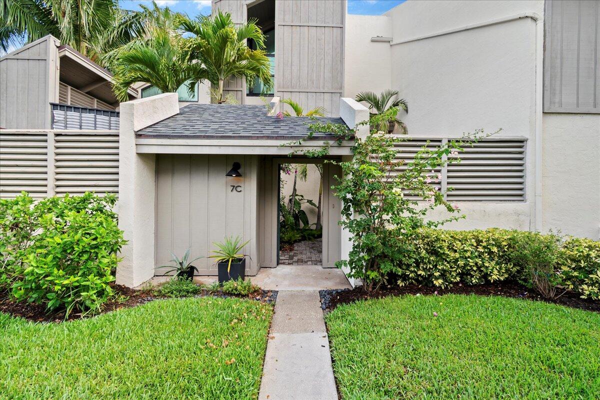1605 Highway 1, Unit 7C Jupiter, FL 33477 - Photo 3 of 31 a front view of a house with garden