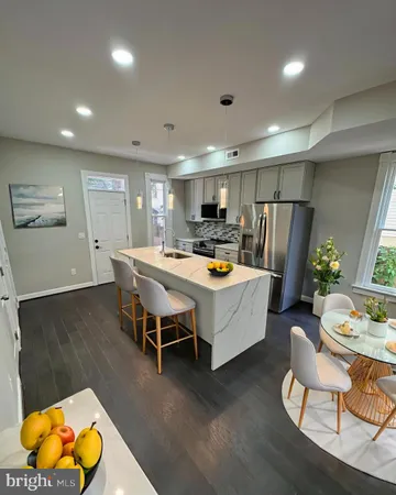 a living room with dining room and wooden floor