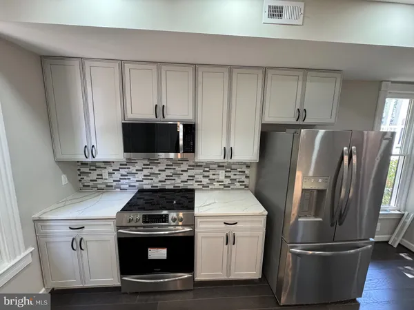 a kitchen with a stove and a refrigerator