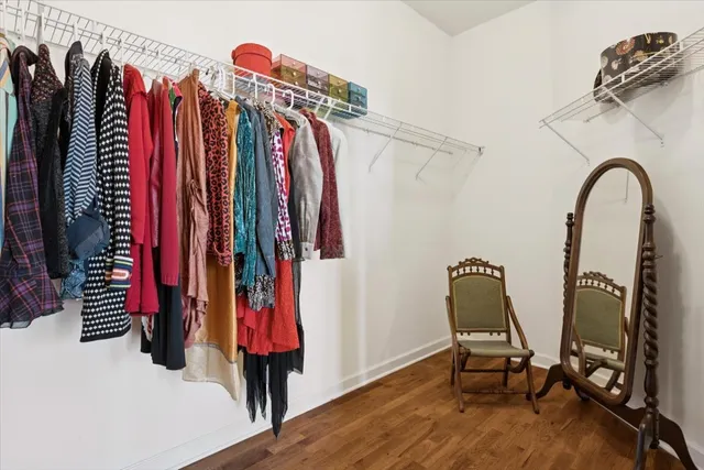a view of walk in closet with clothes