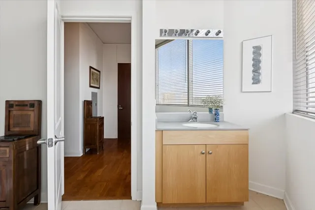 a bathroom with a sink a mirror and a shower