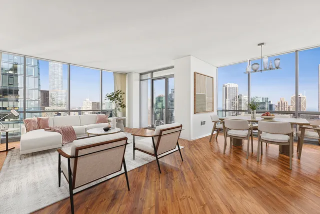 a living room with lots of furniture and a large window