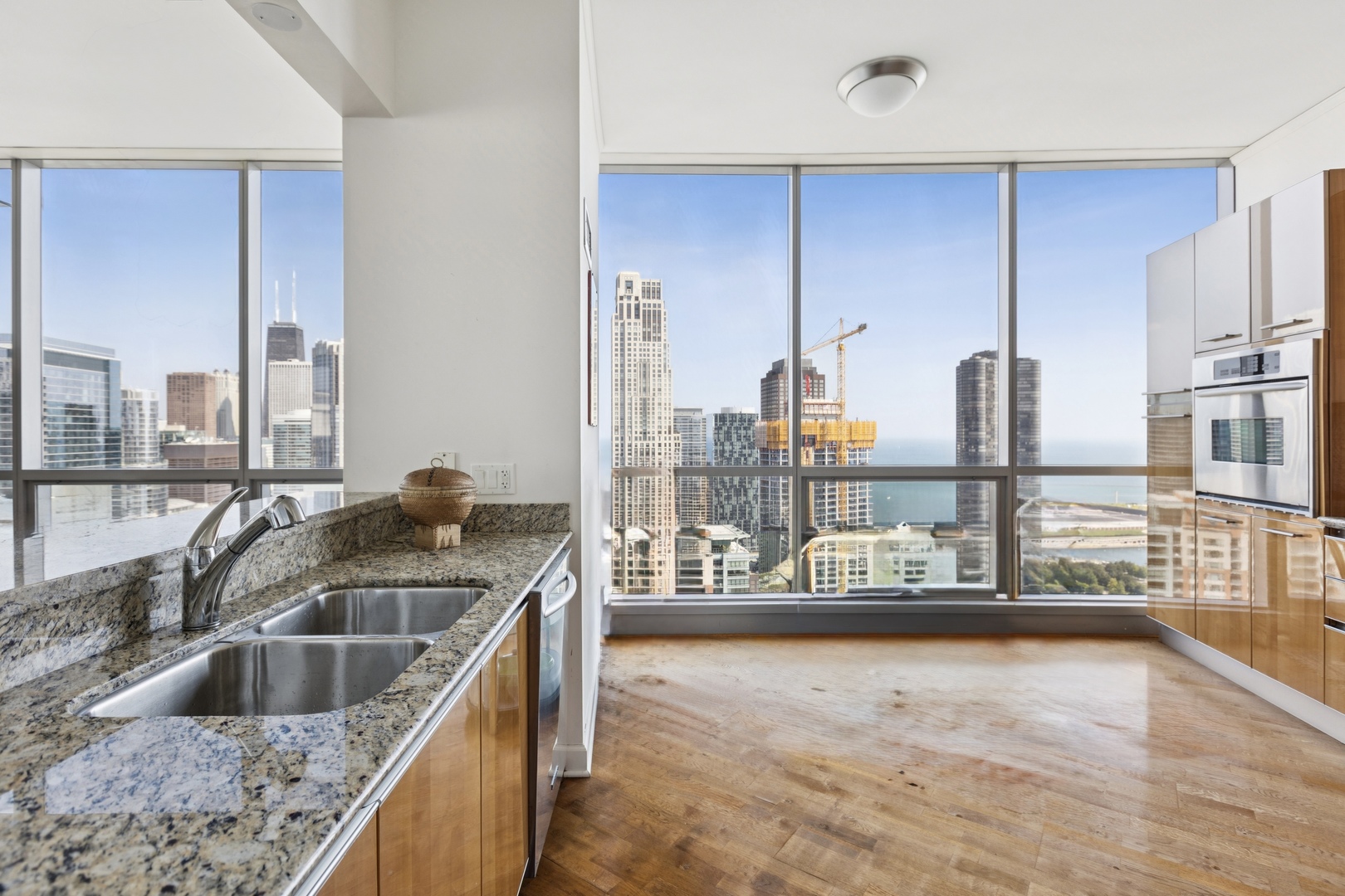 420 East Waterside Drive, Unit 4010 Chicago, IL 60601 - Photo 6 of 39 a kitchen with kitchen island granite countertop a sink a stove and a wooden floors