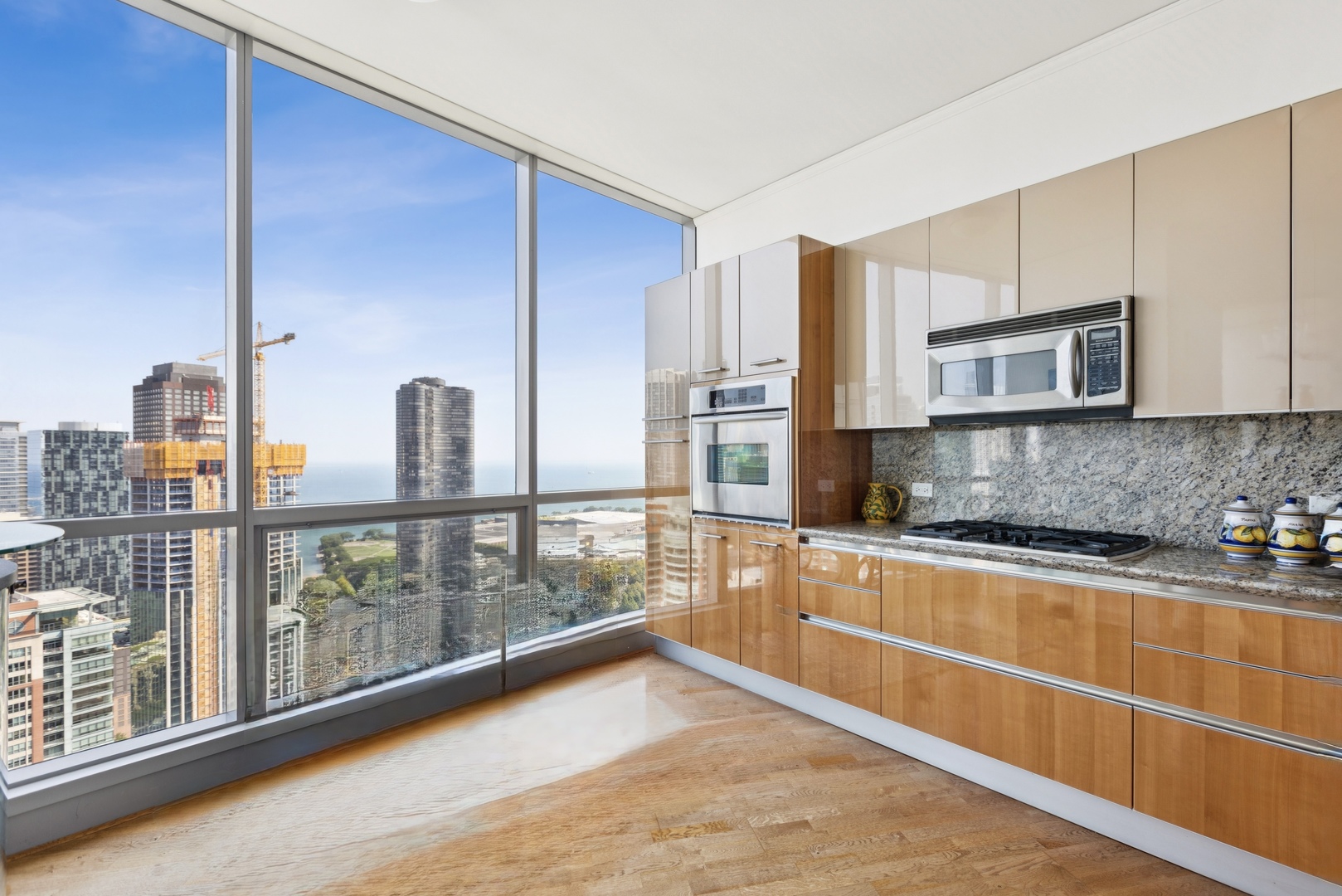 420 East Waterside Drive, Unit 4010 Chicago, IL 60601 - Photo 7 of 39 a kitchen with stainless steel appliances granite countertop a refrigerator a stove and a wooden cabinets