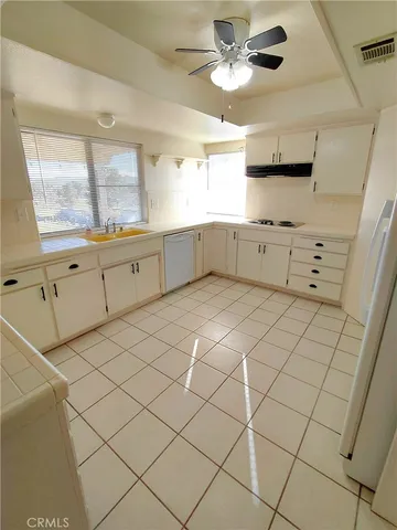 a kitchen with stainless steel appliances cabinets and window