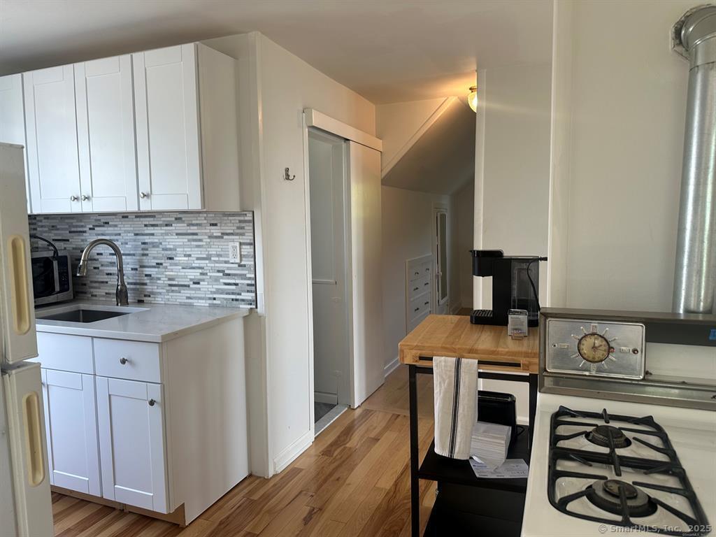 57 Dawson Avenue, Unit 4 West Haven, CT 06516 - Photo 3 of 11 a kitchen with stainless steel appliances granite countertop a stove a sink and a refrigerator