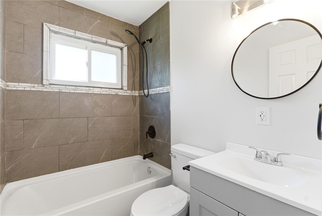 40 Woods Road Springboro, OH 45066 - Photo 45 of 57 This modern bathroom features a sleek vanity and tiled shower, offering comfort and style.
