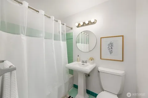 a bathroom with a sink a mirror and a toilet