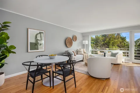 a dining room with furniture and wooden floor