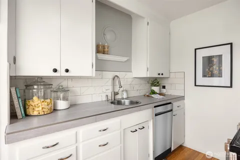 a kitchen with a sink and cabinets