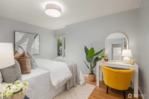 a bedroom with a bed mirror and a table