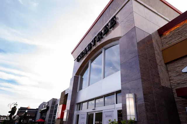 a view of sign board with potted plants
