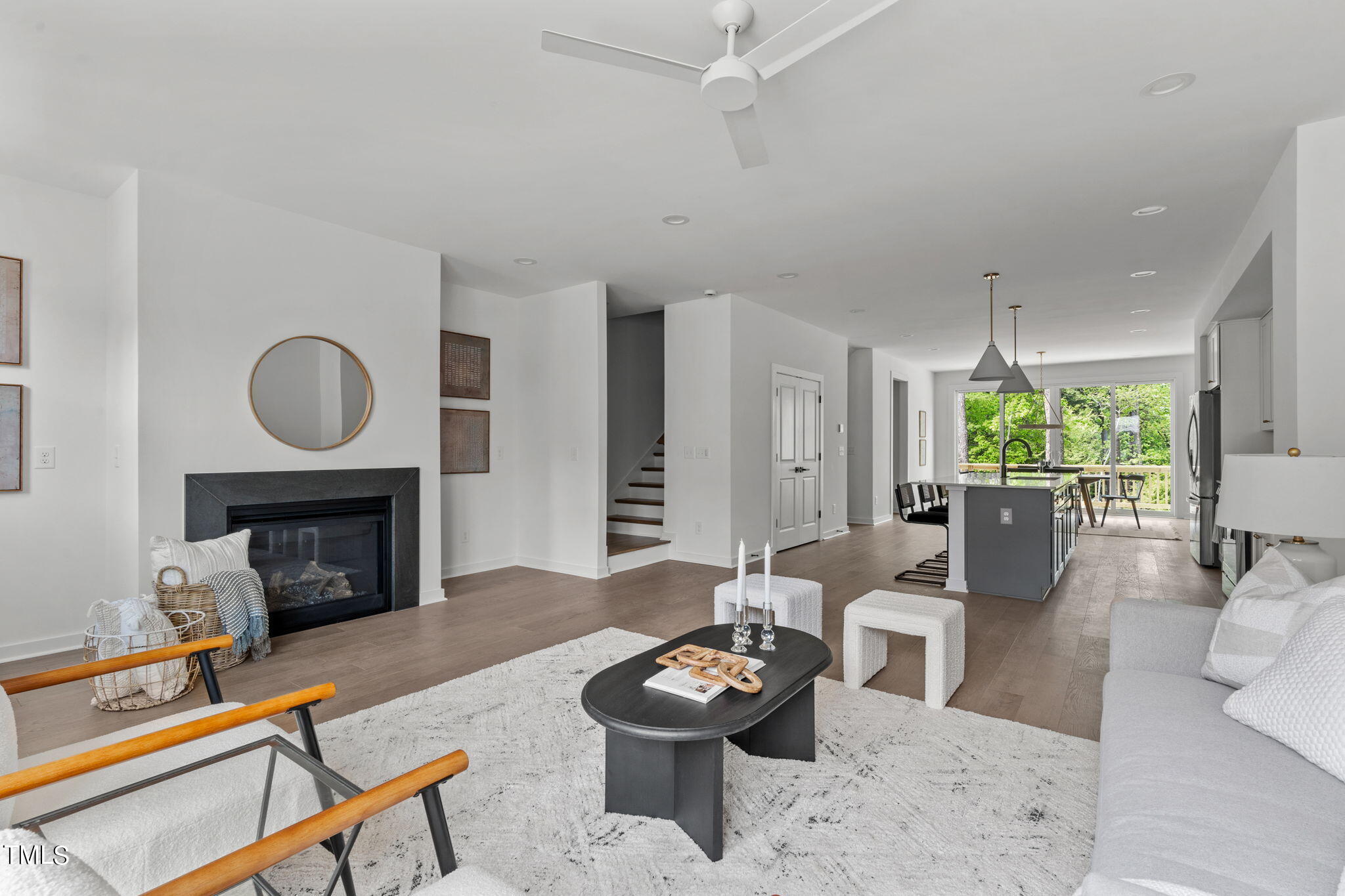 6424 Tanner Oak Lane Raleigh, NC 27613 - Photo 5 of 51 a living room with furniture a fireplace and a chandelier