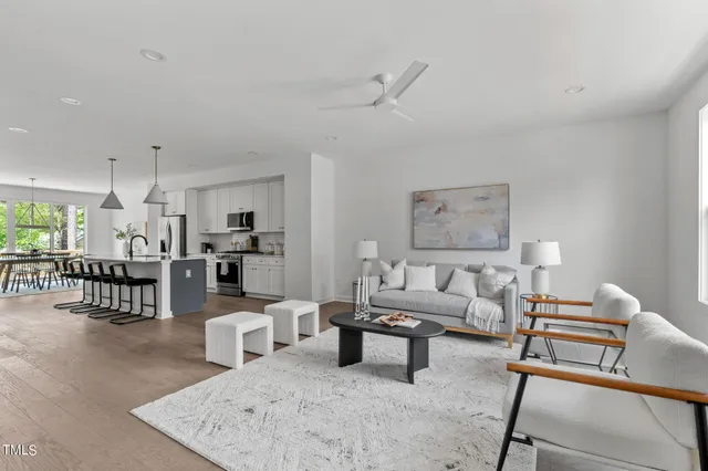 a living room with furniture and kitchen view