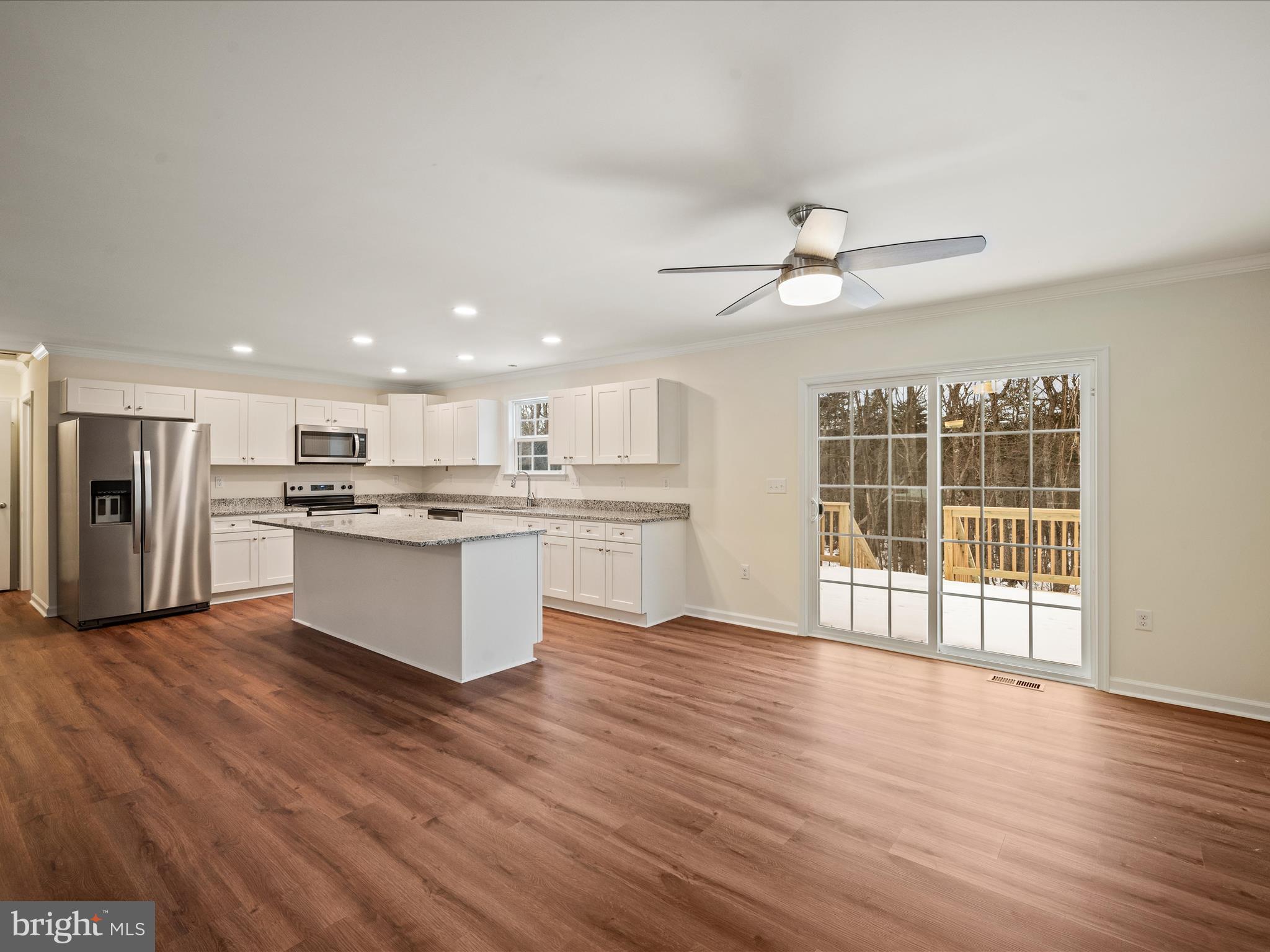 477 North Timber Ridge Road Cross Junction, VA 22625 - Photo 11 of 42 a view of kitchen with granite countertop stainless steel appliances cabinets a wooden floor and a window