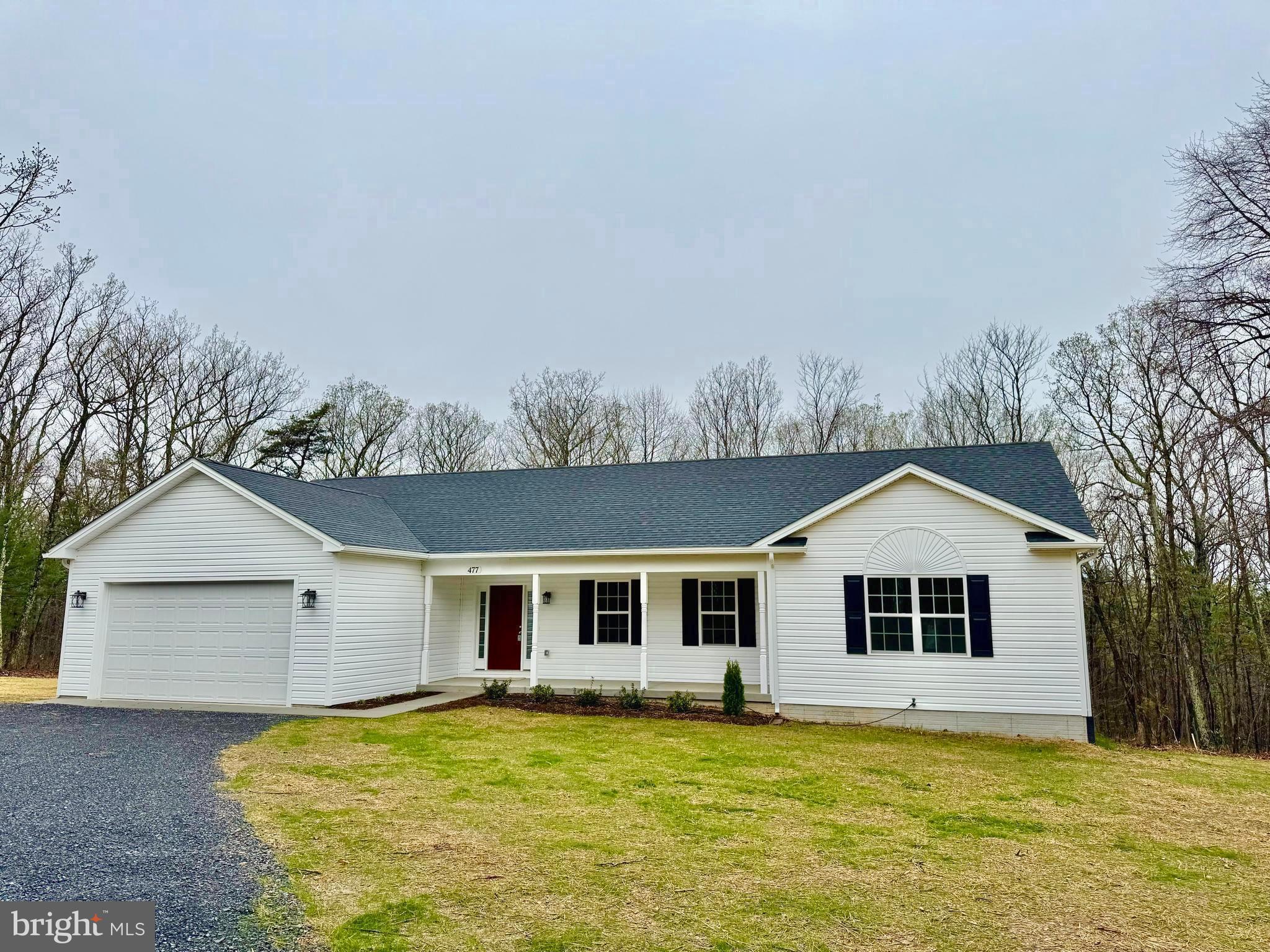 477 North Timber Ridge Road Cross Junction, VA 22625 - Photo 41 of 42 a front view of house with yard and trees in the background