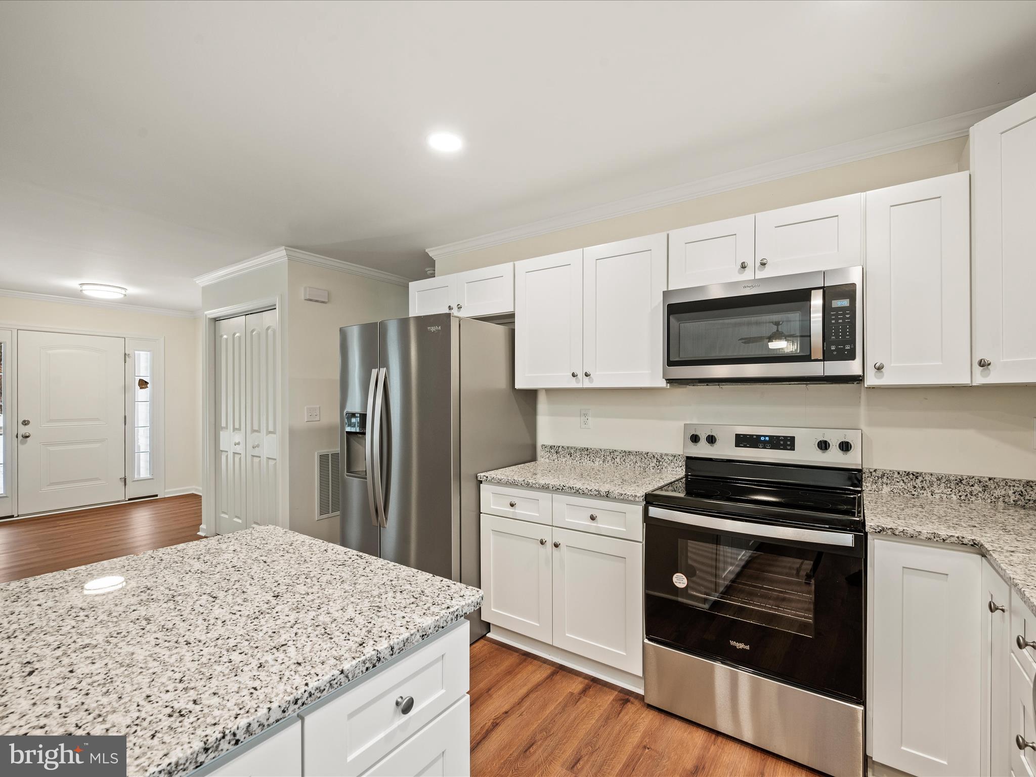 477 North Timber Ridge Road Cross Junction, VA 22625 - Photo 8 of 42 a kitchen with stainless steel appliances granite countertop a stove a microwave and a refrigerator