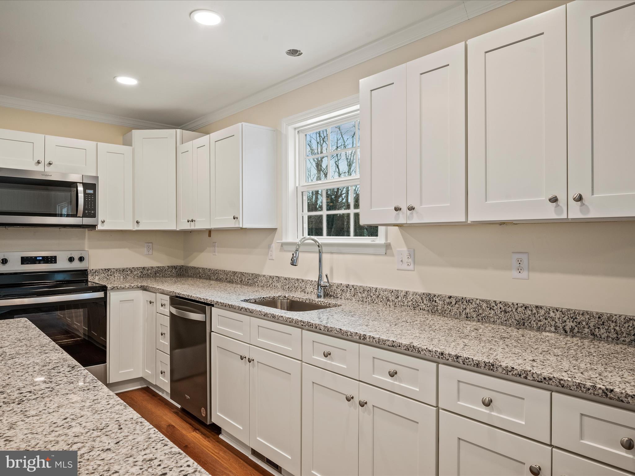 477 North Timber Ridge Road Cross Junction, VA 22625 - Photo 9 of 42 a kitchen with granite countertop white cabinets and stainless steel appliances