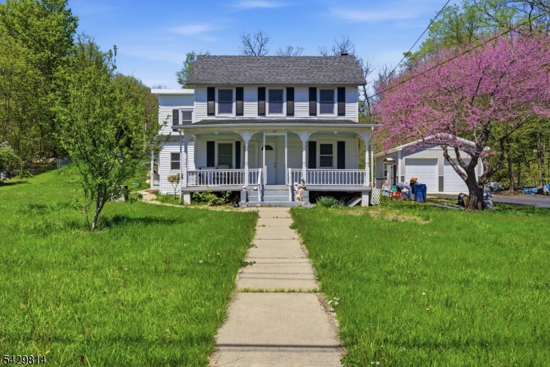 251 Russia Road Oak Ridge, NJ 07438 - Photo 2 of 34 a front view of house with yard and green space