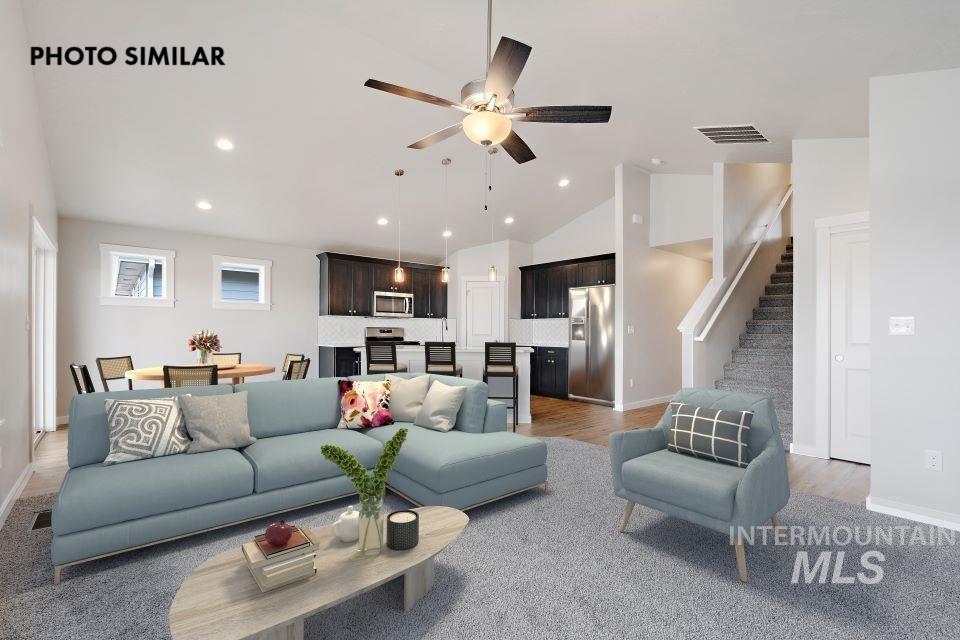 925 Twilight Weiser, ID 83672 - Photo 7 of 31 Open-concept living space featuring vaulted ceilings, recessed lighting, wood-finish flooring, a ceiling fan, and a staircase with carpeted treads