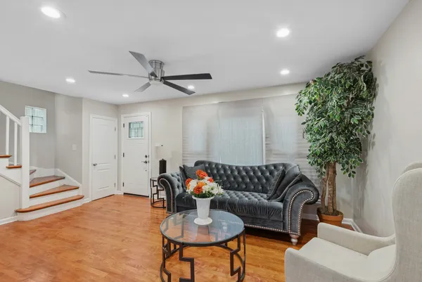 a living room with furniture and a potted plant