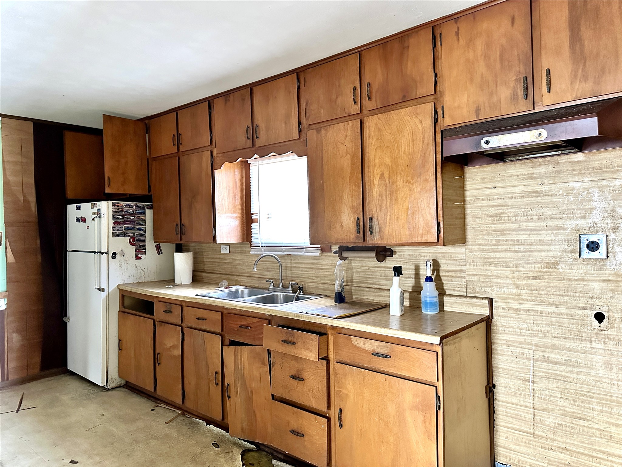 1148 Old Nails Creek Road Giddings, TX 78942 - Photo 6 of 23 a kitchen with stainless steel appliances a sink cabinets and a refrigerator