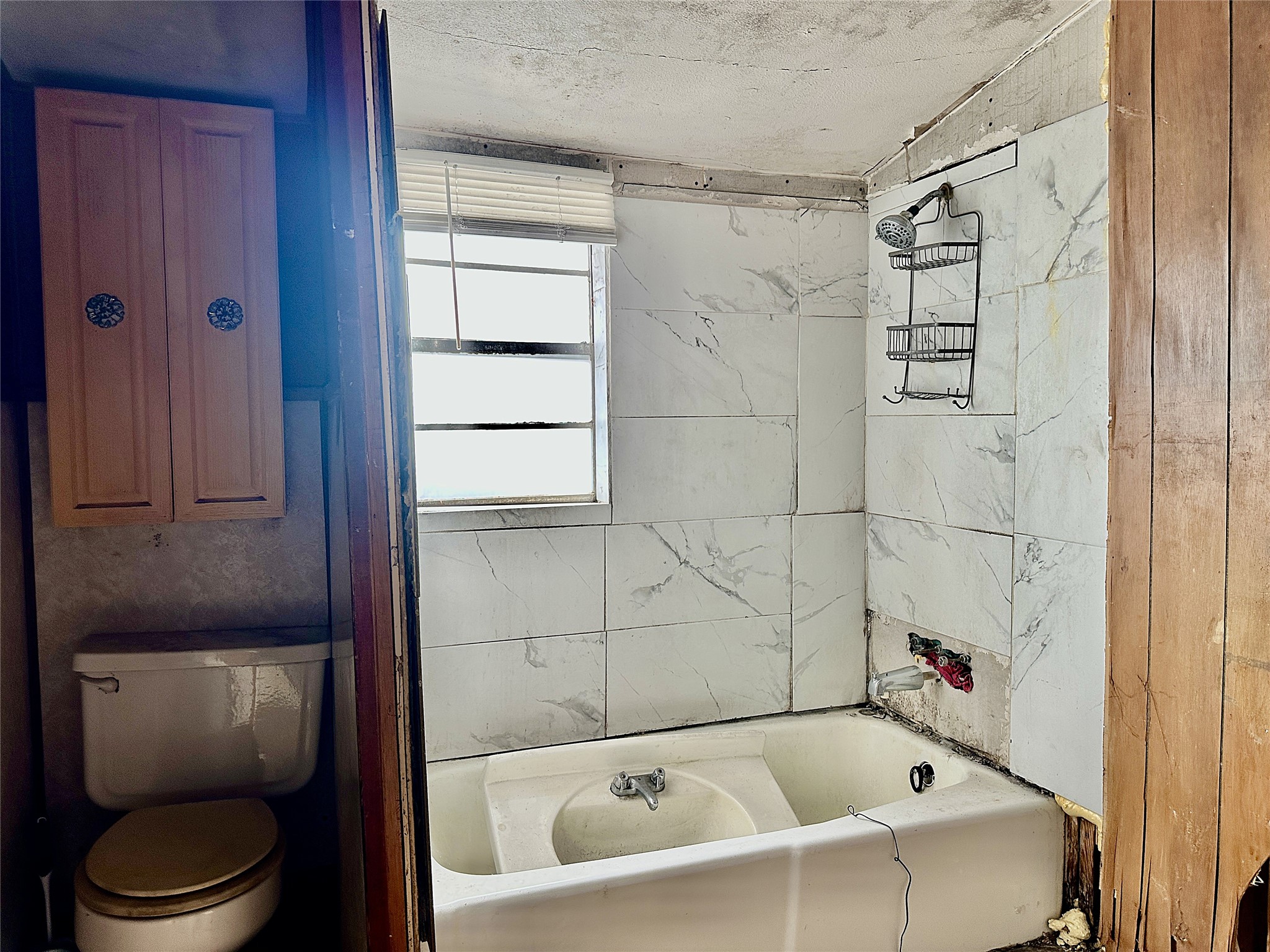 1148 Old Nails Creek Road Giddings, TX 78942 - Photo 10 of 23 a white bath tub sitting next to a white toilet