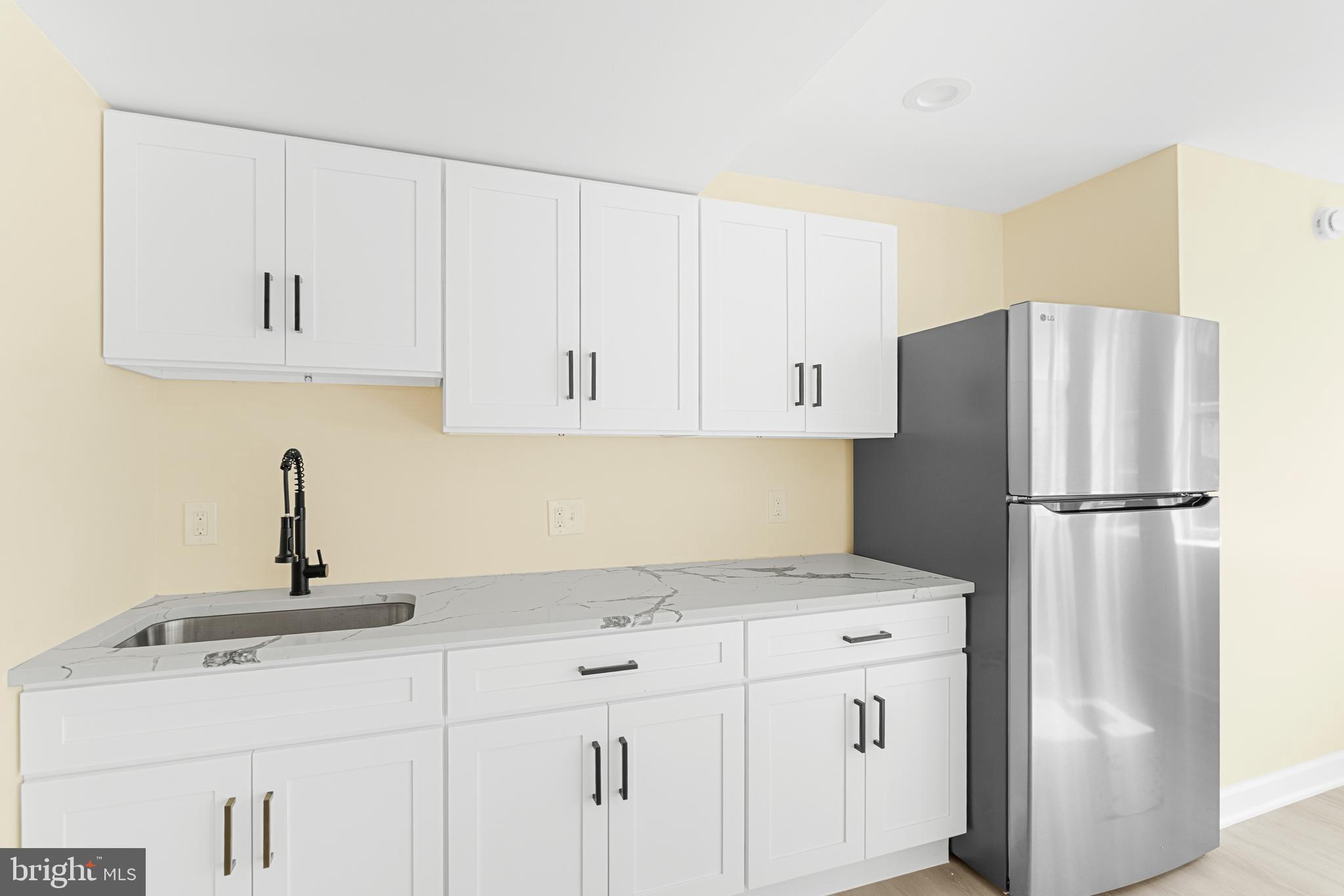 1349 Yorktown Road Annapolis, MD 21409 - Photo 17 of 35 a kitchen with white cabinets and refrigerator