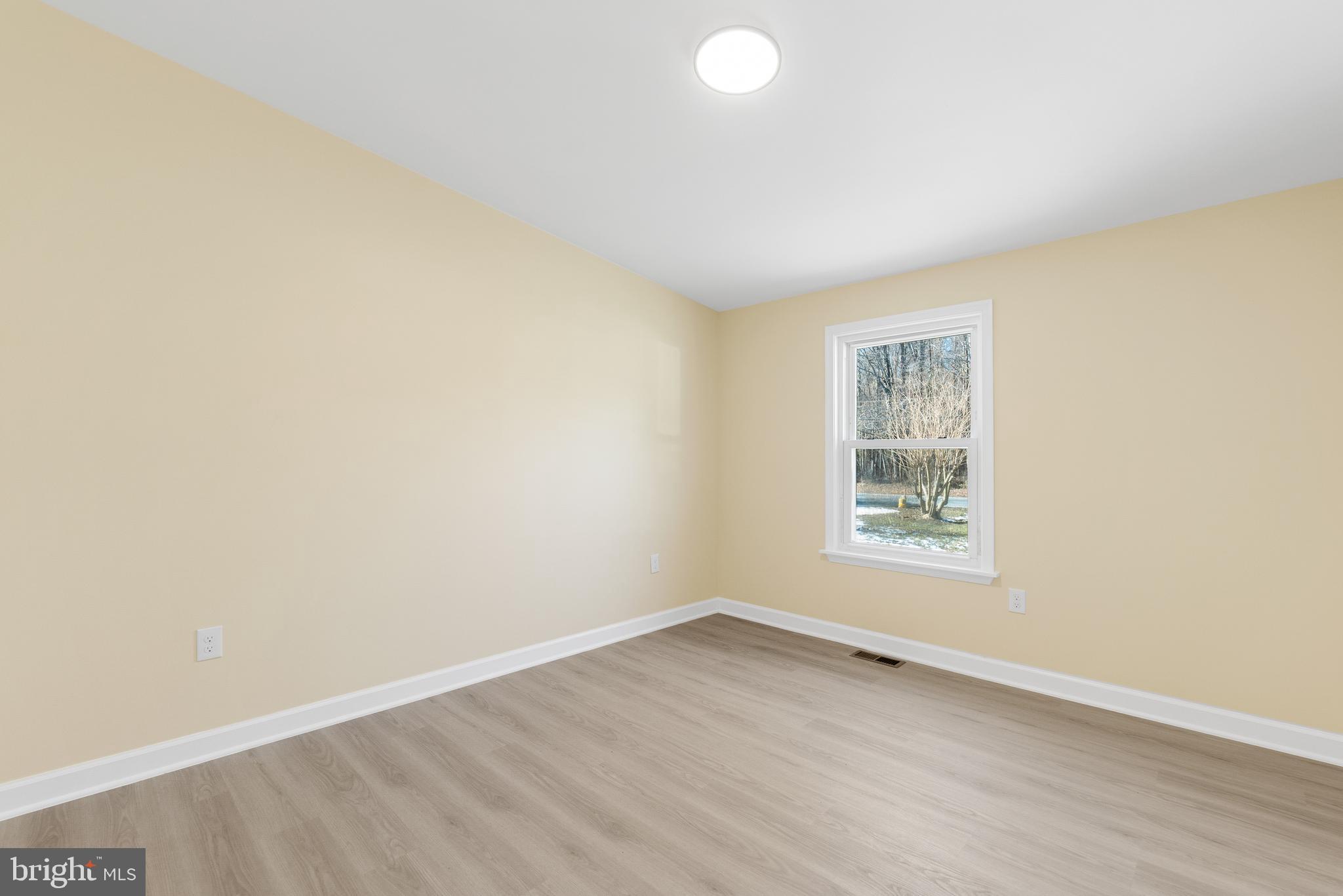 1349 Yorktown Road Annapolis, MD 21409 - Photo 20 of 35 an empty room with wooden floor and windows