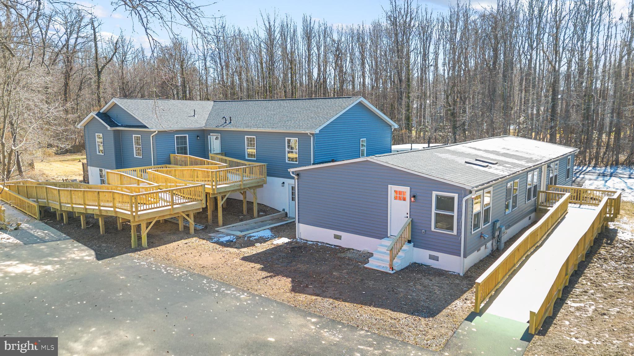 1349 Yorktown Road Annapolis, MD 21409 - Photo 2 of 35 a terrace of a house with barbeque oven and large trees