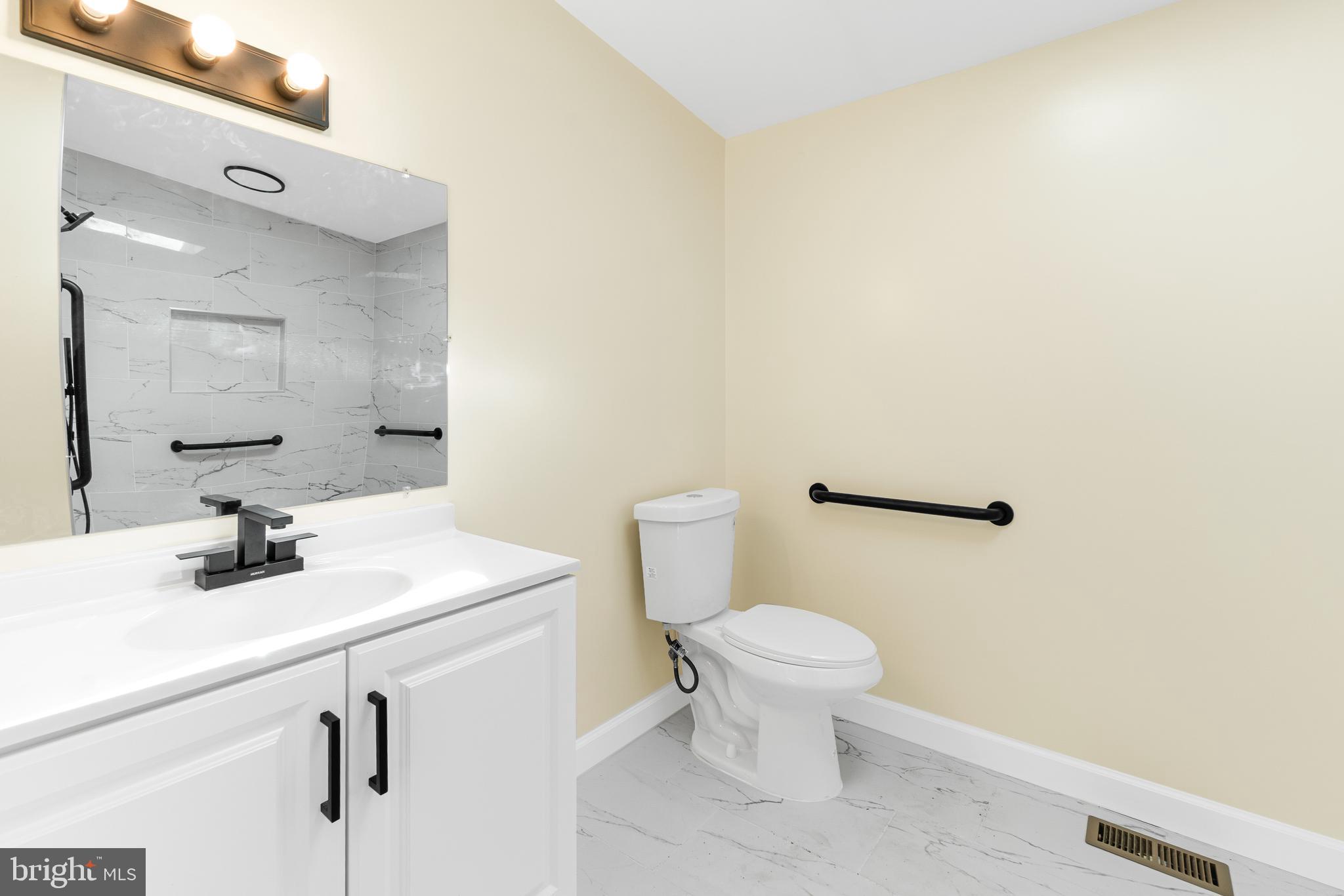 1349 Yorktown Road Annapolis, MD 21409 - Photo 22 of 35 a bathroom with a toilet sink and mirror