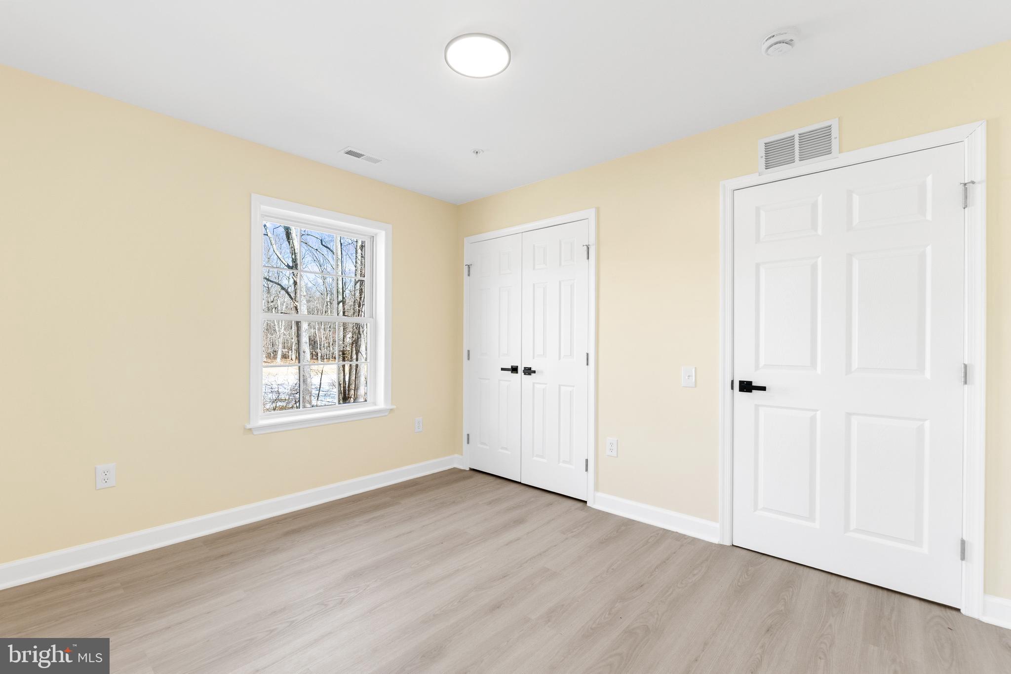 1349 Yorktown Road Annapolis, MD 21409 - Photo 30 of 35 a view of an empty room with wooden floor and a window