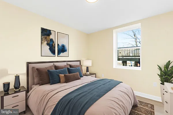 a bedroom with a bed and a painting on the wall
