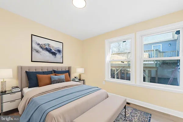 a bedroom with bed and a large window