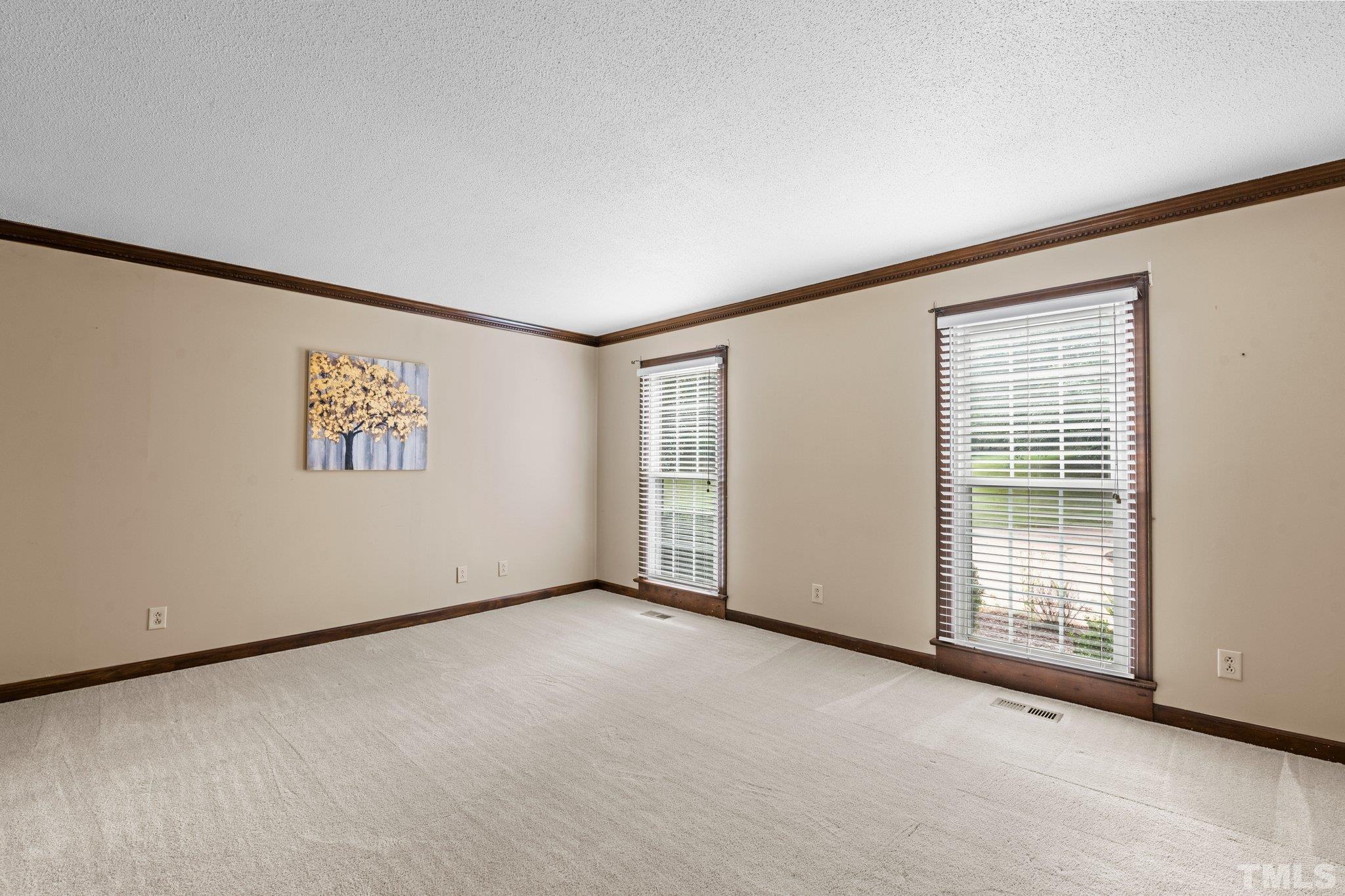 7525 South Tanglewild Drive Raleigh, NC 27613 - Photo 12 of 50 a view of an empty room with a window