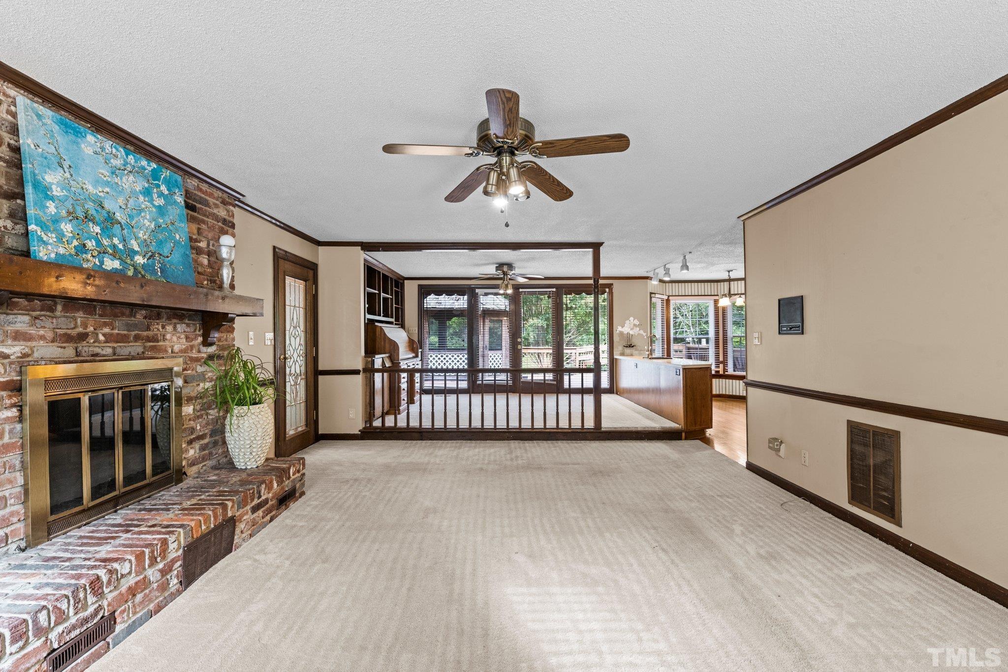7525 South Tanglewild Drive Raleigh, NC 27613 - Photo 13 of 50 a view of livingroom with furniture and fireplace