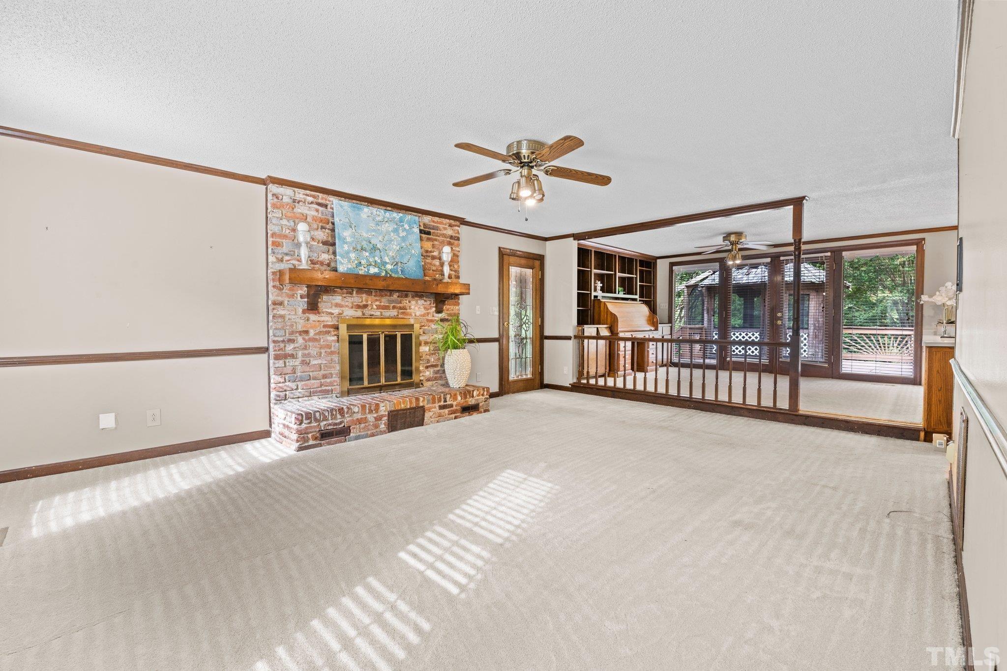 7525 South Tanglewild Drive Raleigh, NC 27613 - Photo 15 of 50 a view of a livingroom with a furniture window hardwood floor and a ceiling fan