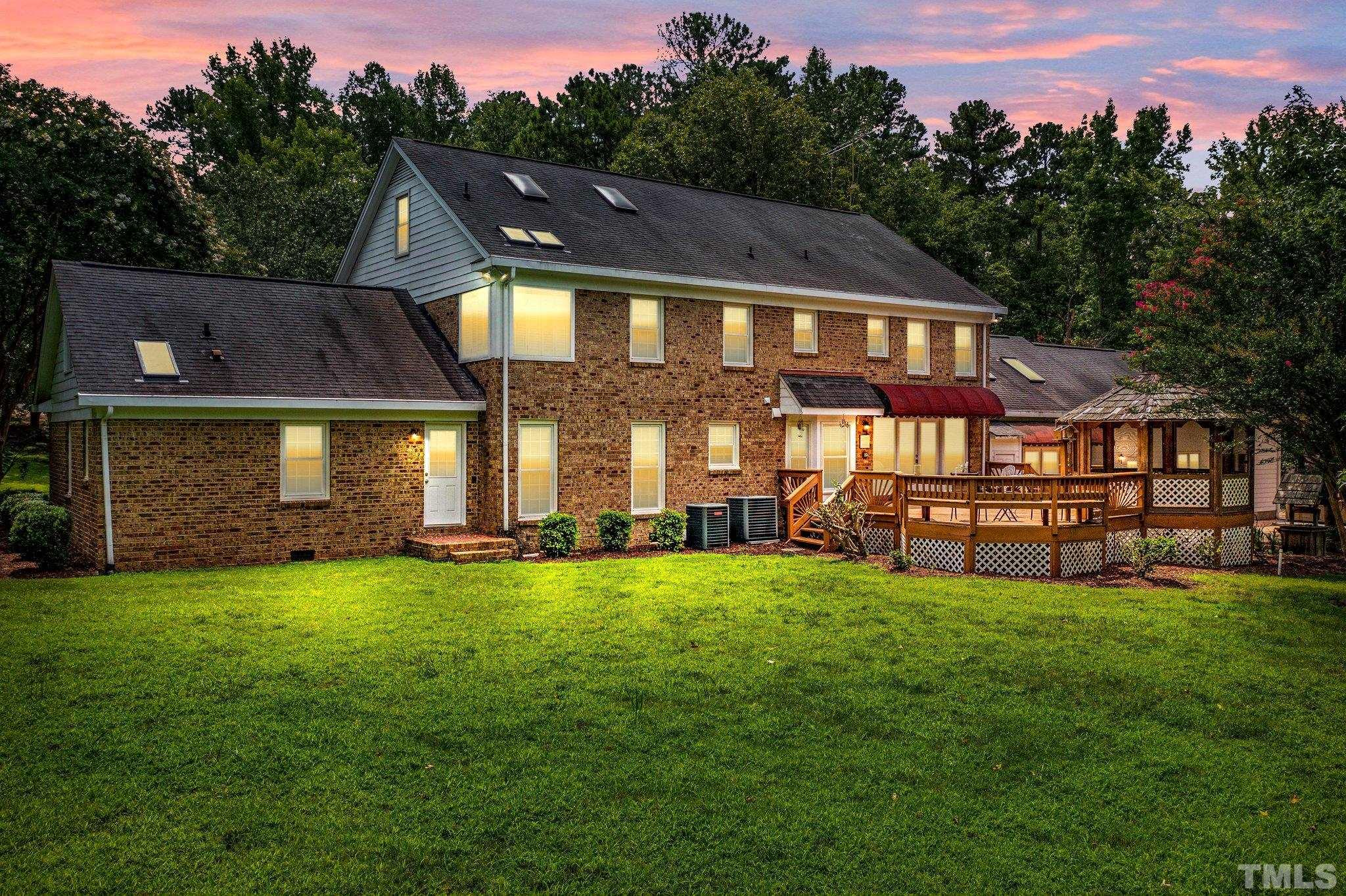 7525 South Tanglewild Drive Raleigh, NC 27613 - Photo 2 of 50 a view of a house with a yard and sitting area