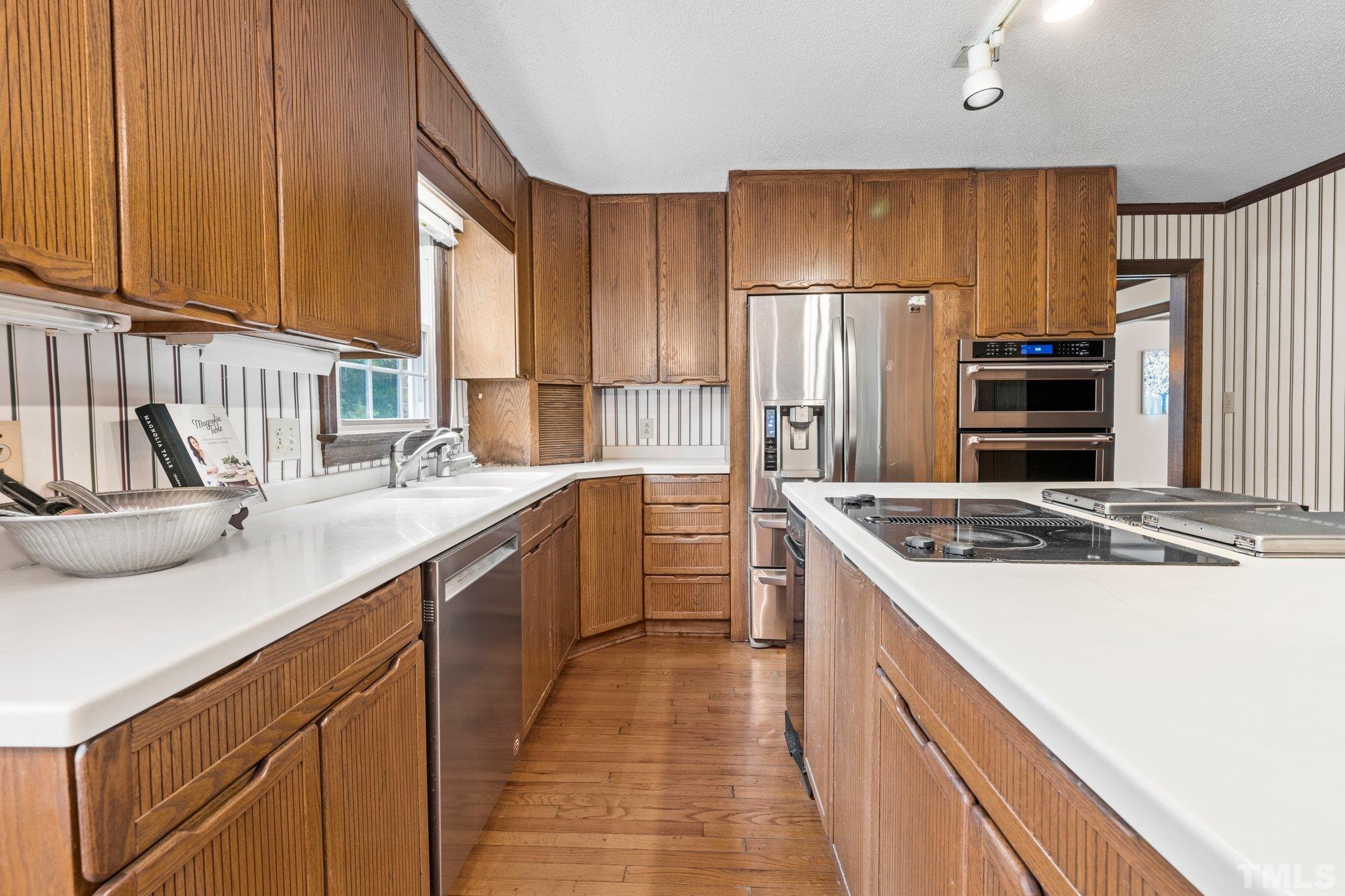 7525 South Tanglewild Drive Raleigh, NC 27613 - Photo 23 of 50 a kitchen with a sink stove and refrigerator