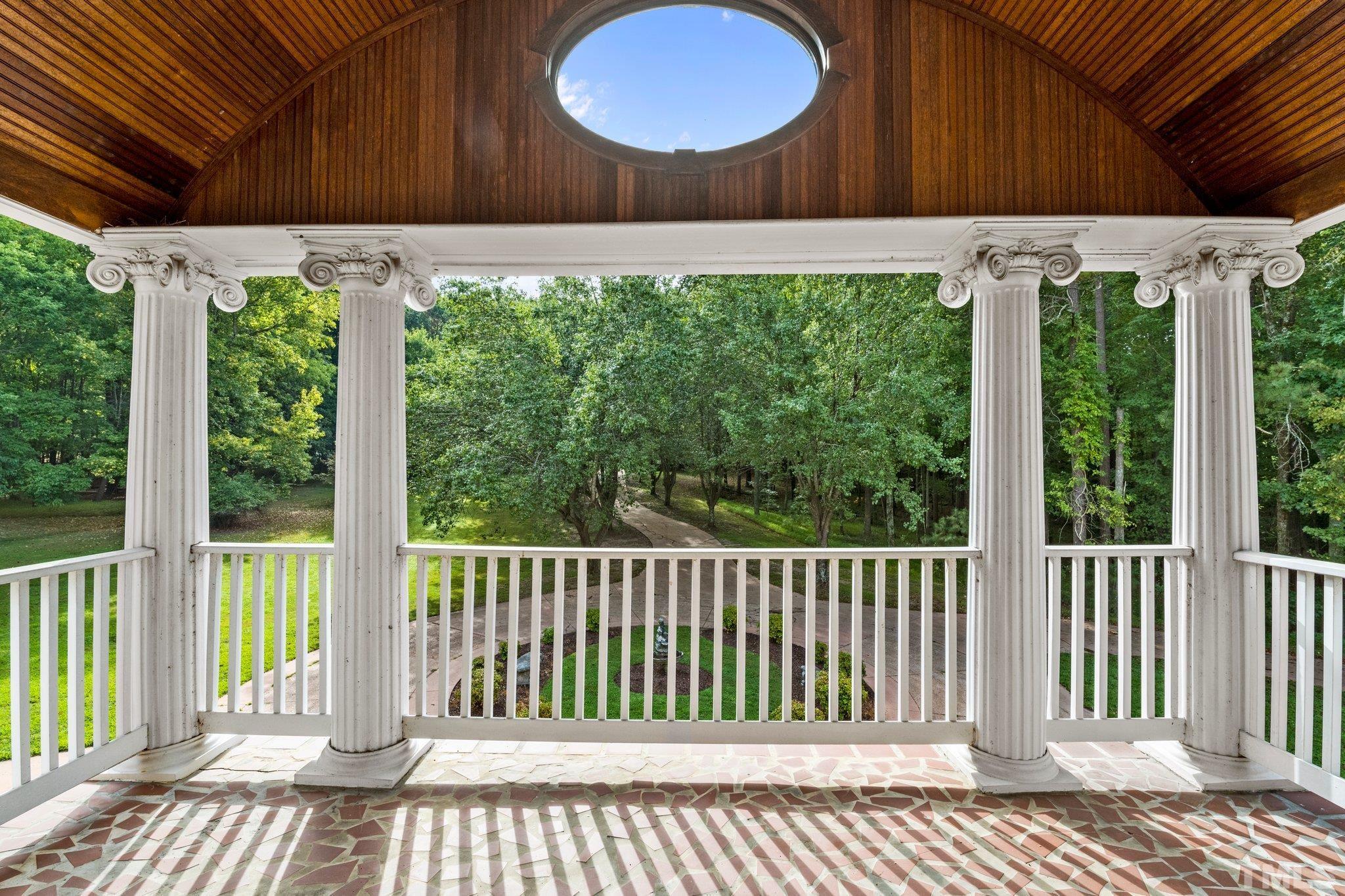 7525 South Tanglewild Drive Raleigh, NC 27613 - Photo 26 of 50 a view of a backyard with a small grill and wooden fence