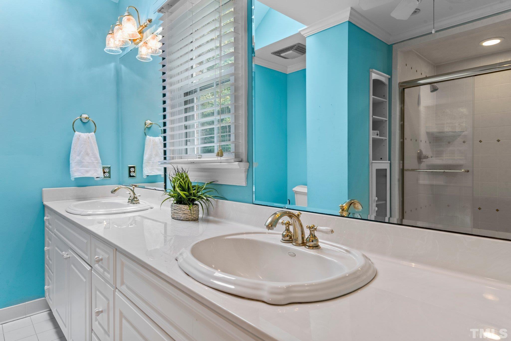 7525 South Tanglewild Drive Raleigh, NC 27613 - Photo 28 of 50 a bathroom with a sink and a mirror