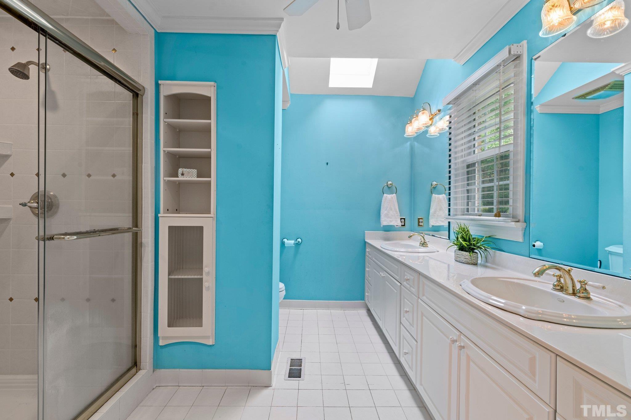7525 South Tanglewild Drive Raleigh, NC 27613 - Photo 29 of 50 a bathroom with a granite countertop sink a mirror and a shower