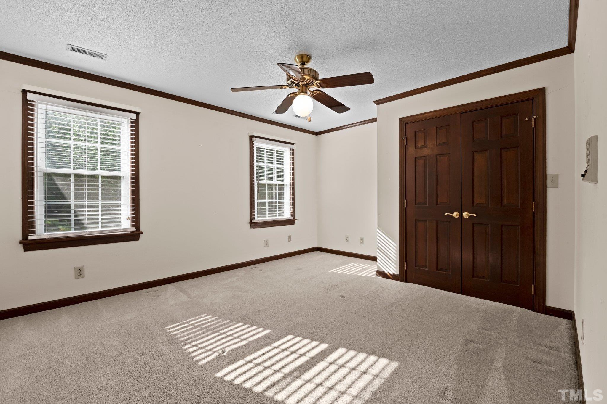 7525 South Tanglewild Drive Raleigh, NC 27613 - Photo 33 of 50 a view of empty room with windows and fan