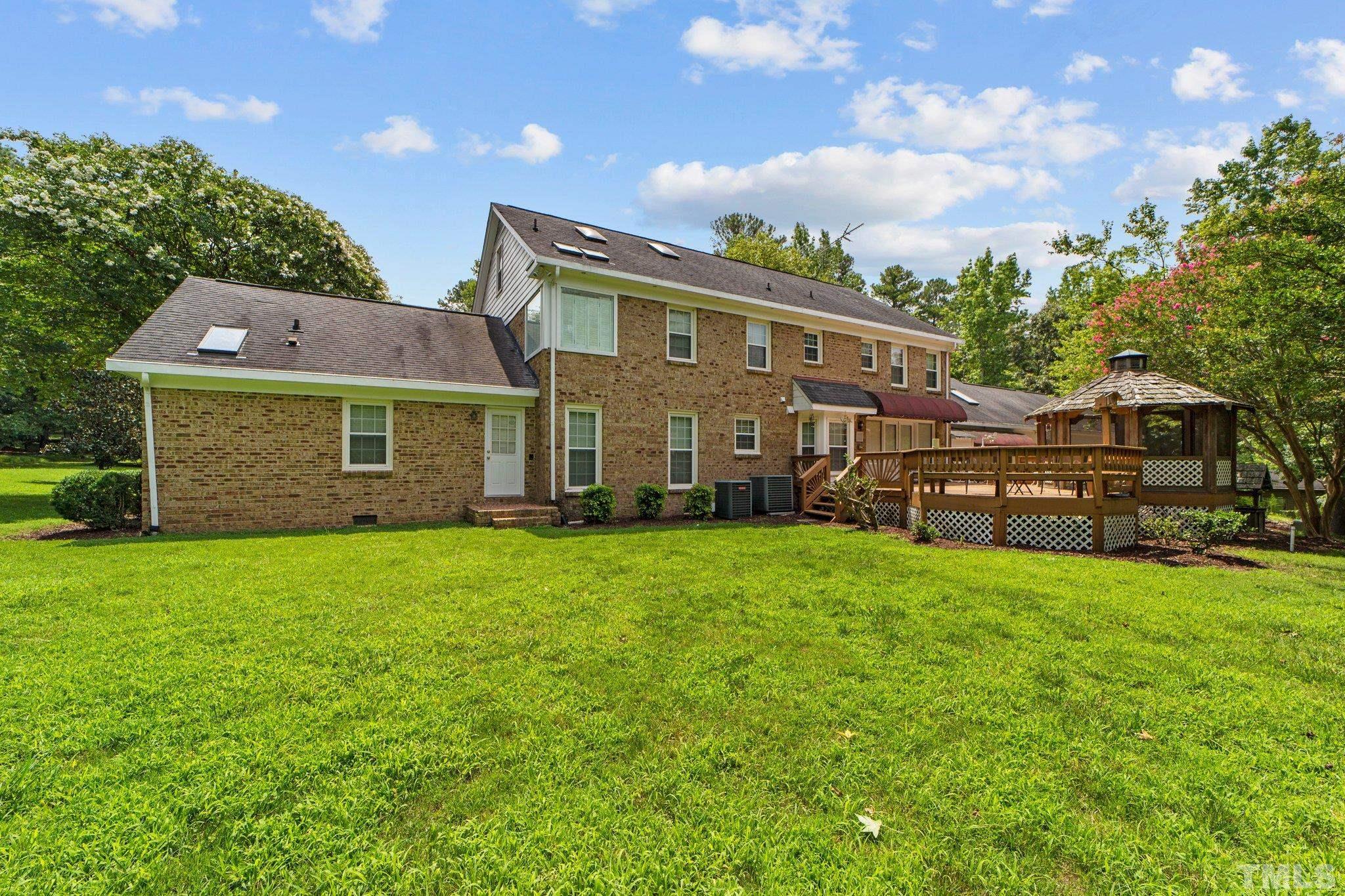 7525 South Tanglewild Drive Raleigh, NC 27613 - Photo 36 of 50 a view of a house with backyard and garden
