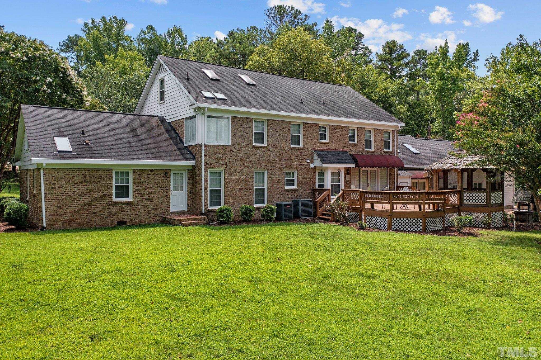 7525 South Tanglewild Drive Raleigh, NC 27613 - Photo 37 of 50 a aerial view of a house with a yard and a large tree