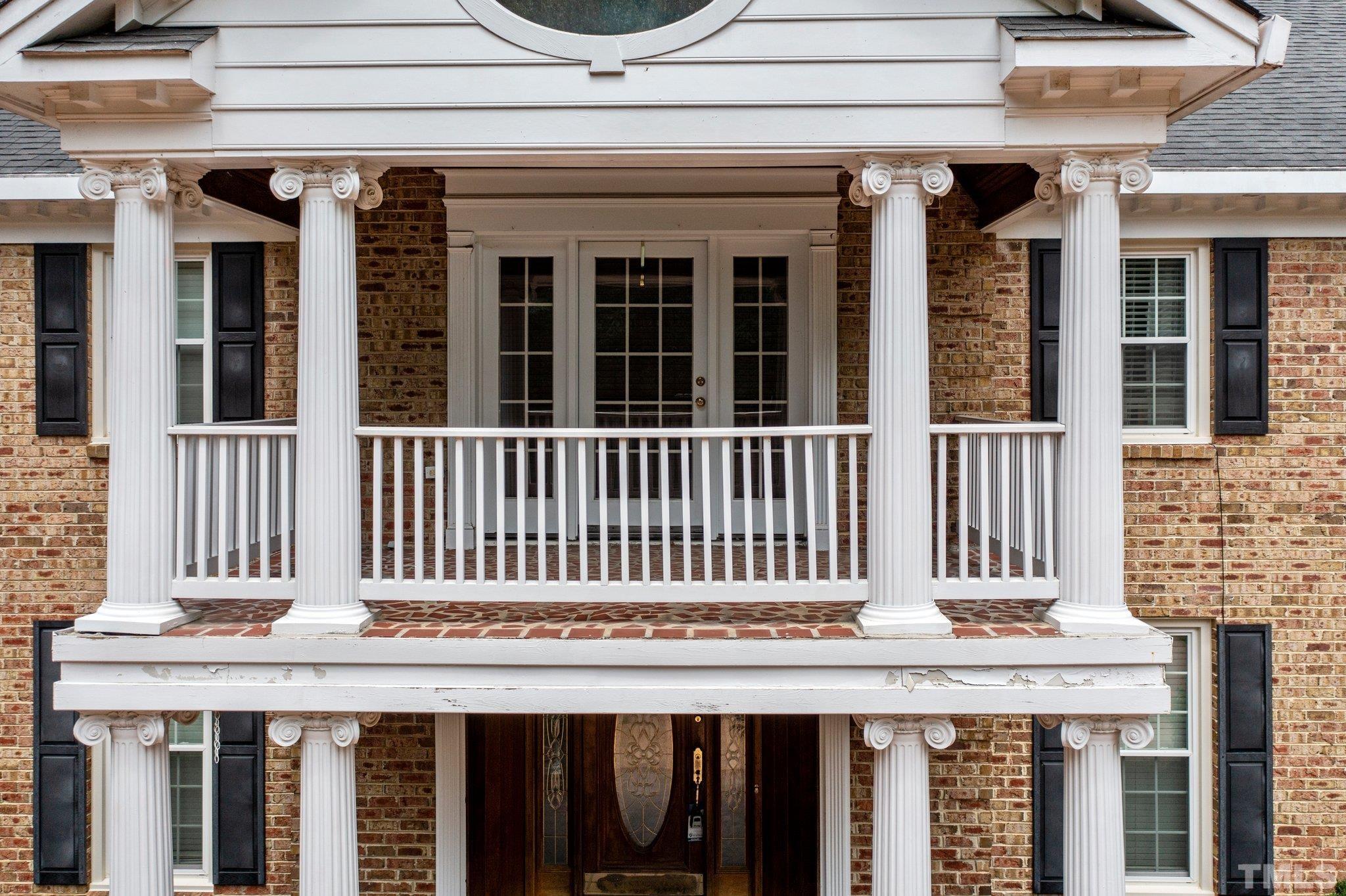 7525 South Tanglewild Drive Raleigh, NC 27613 - Photo 7 of 50 a view of a brick house with large windows