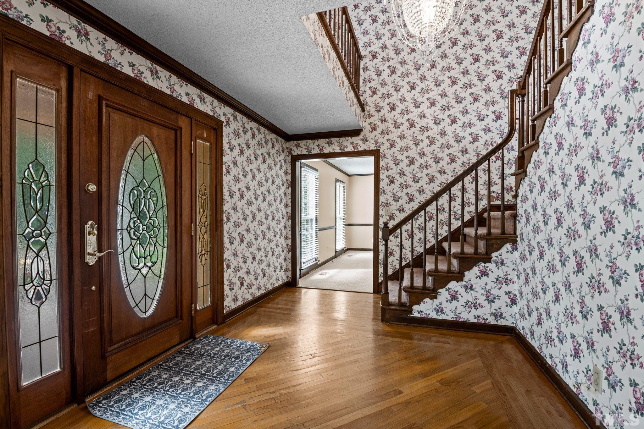 7525 South Tanglewild Drive Raleigh, NC 27613 - Photo 8 of 50 a view of entryway with wooden floor
