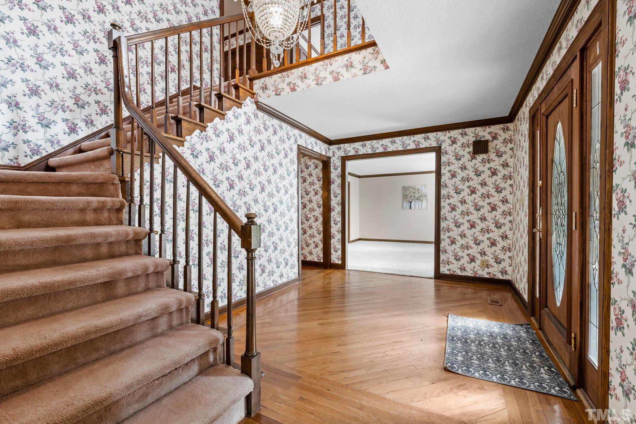 7525 South Tanglewild Drive Raleigh, NC 27613 - Photo 9 of 50 a view of an entryway with wooden floor