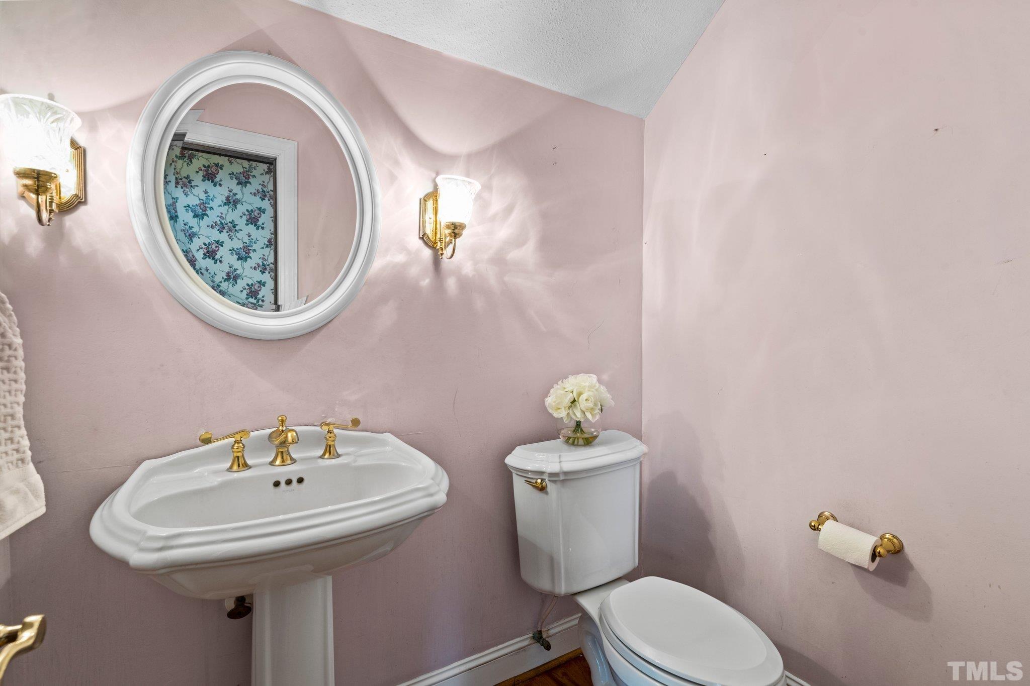 7525 South Tanglewild Drive Raleigh, NC 27613 - Photo 10 of 50 a bathroom with a toilet a sink and mirror