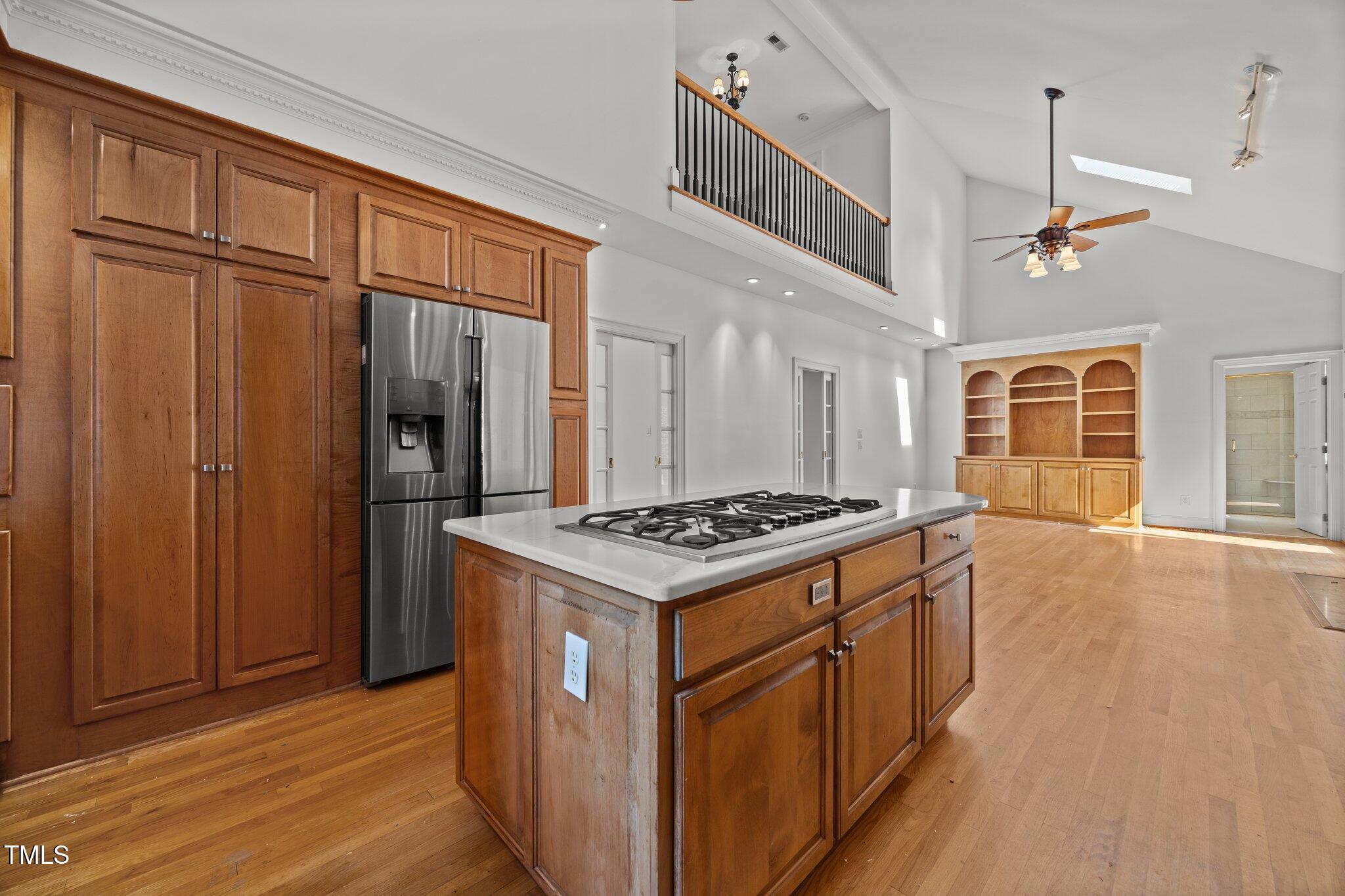 3604 Eden Croft Drive Raleigh, NC 27612 - Photo 16 of 49 a kitchen that has a stove and a wooden cabinets